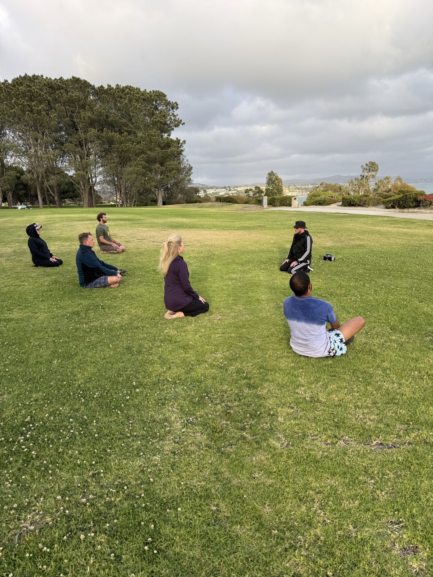 KCJK group sitting in a circle on the grass, welcoming a mix of experience levels