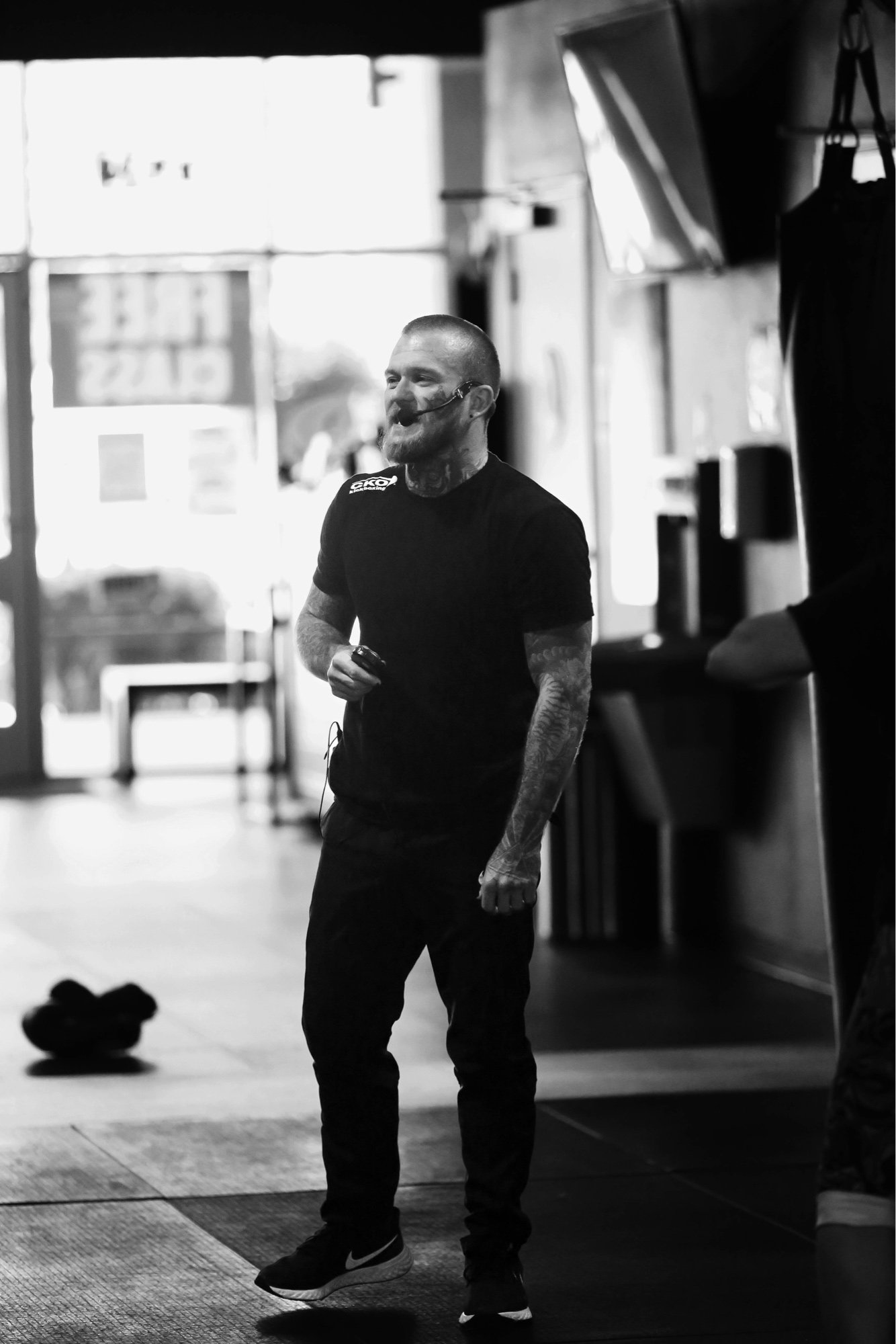 Shaun Anderson coaching in the gym, black and white candid photo